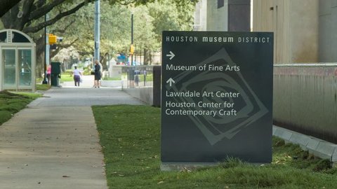 Sidewalk Street Scene at Houston Museum District in Hermann Park with a Sign Directing to the Museum of Fine Arts, Lawndale Arts Center, and the Houston Center for Contemporary Art
