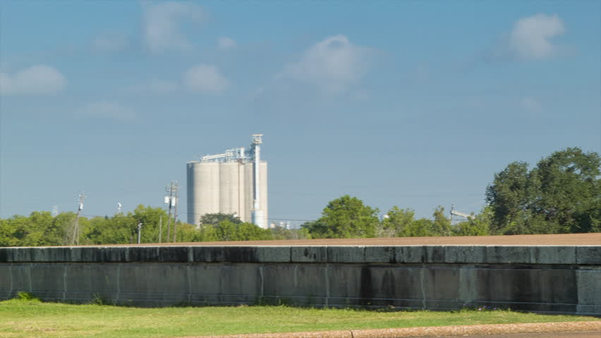 San Jacinto Battleground featuring the Battleship Texas in Houston TX Ship Channel with Waving Flags at the San Jacinto Memorial and Museum on Warm and Sunny Summers Texas Morning