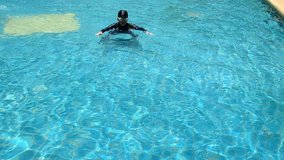 Boy was swimming in pool having fun.
