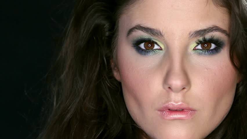 Portrait of beautiful young woman on black background 