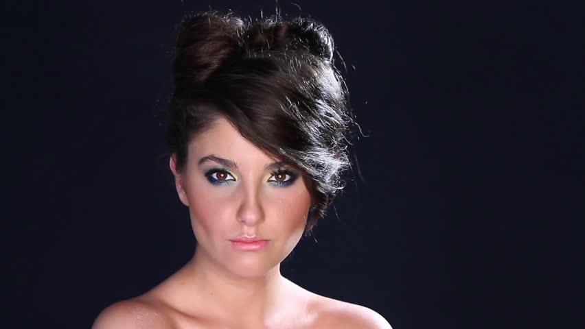 Portrait of beautiful young woman on black background  