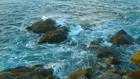 Video 3840x2160 UHD - Evening landscape. The rocky coast of the ocean. Waves and large stones