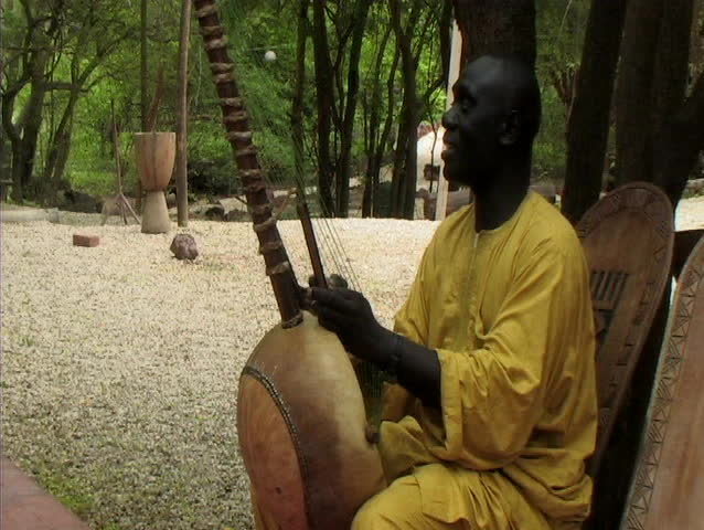 Senegalese man playing instrument and singing