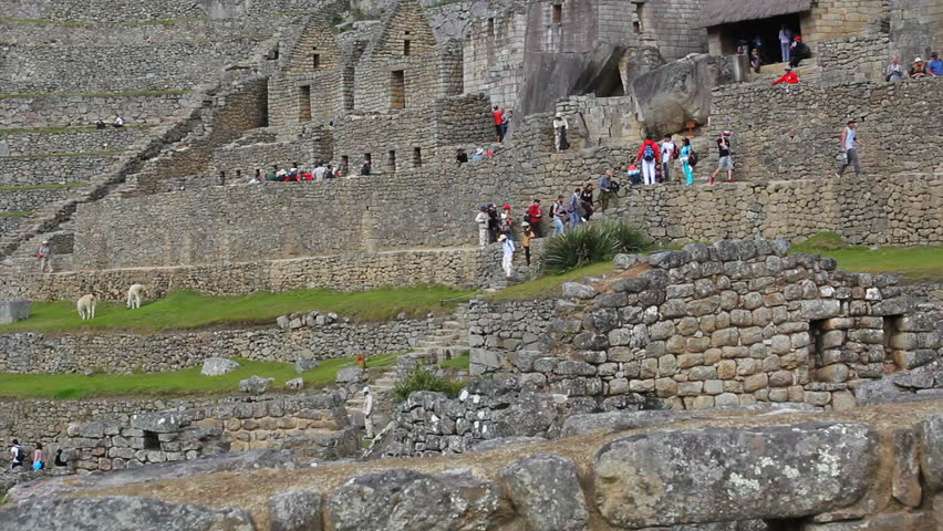 MACHU PICCHU, PERU - CIRCA AUGUST 2014 - Tourists visiting Inkas House Machu Picchu, Peru - UNESCO World Heritage Site