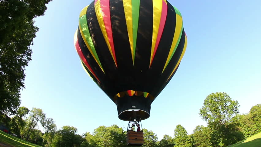 A hot air balloon lifts of the ground.