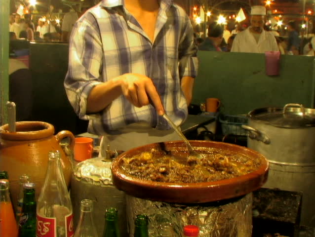 Chef in morocco posing for camera with food