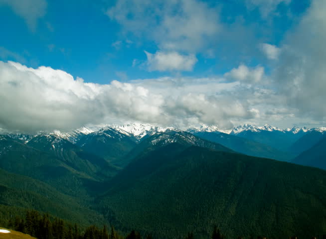 Time lapse of clouds passing over the Olympic mountains in Washington state, USA.  2 static shots, 2 with slow zoom/pan.