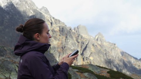 Close up of hiker young woman holding in her hand GPS navigator
