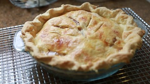 Baking a delicious apple pie for dessert in her home kitchen Stock Video