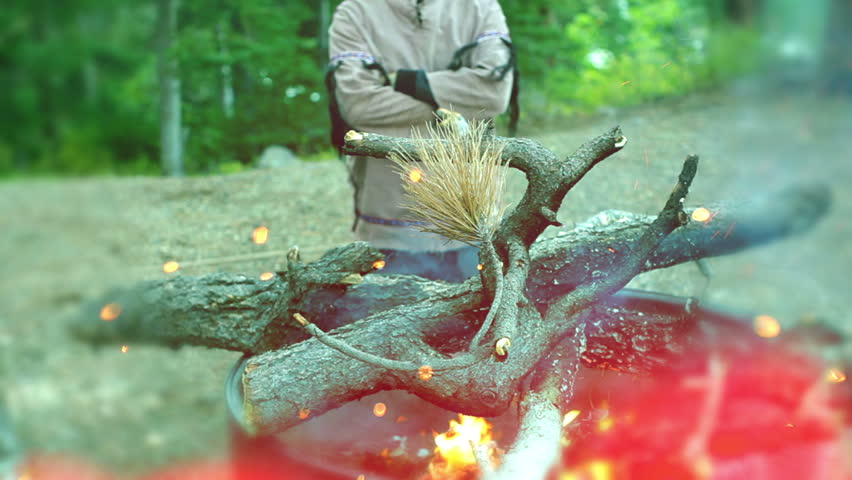 native american watching fire