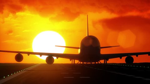 Jet plane departs from airport runway as silhouette in front of large sunset / sunrise 4K UltraHD