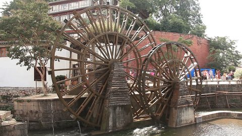 LIJIANG, CHINA - SEPTEMBER, 2014: famous watermill in Dayan old town, Lijiang, China on September, 2014. Lijiang is one of the most beautiful cities of China with a rich culture and history.