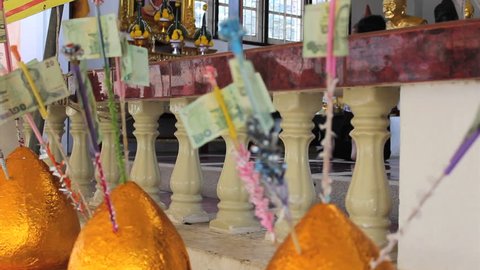HUA HIN, THAILAND, OCTOBER 2014: Gold money trees wait patiently for more money to come from Thai Buddhists making merit at the temple in Hua Hin, Thailand.