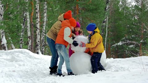 Group of kids making a snowman together