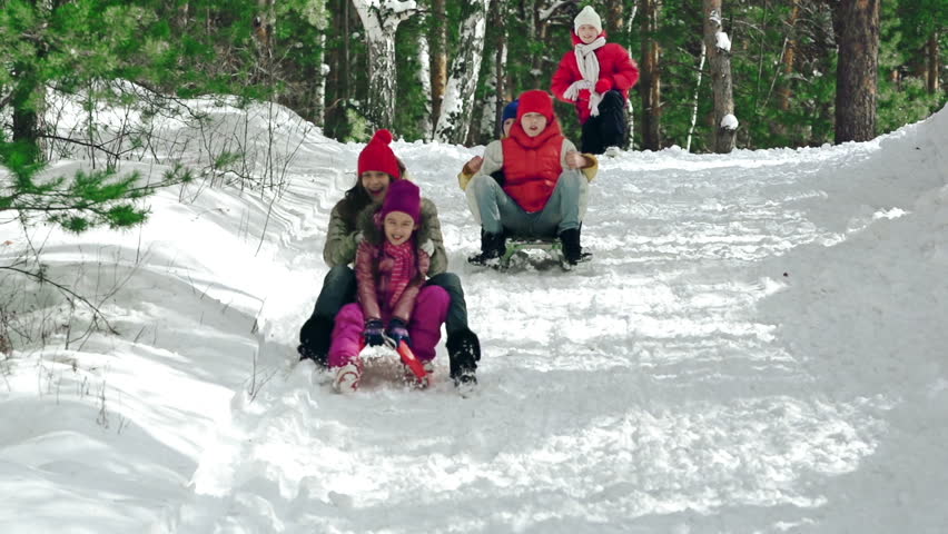 Two by two down the hill ride on sledges in slow motion
