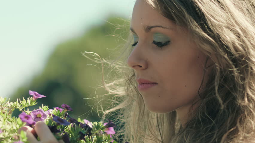 pensive girl is touching flowers: thoughtful girl with some problem in love