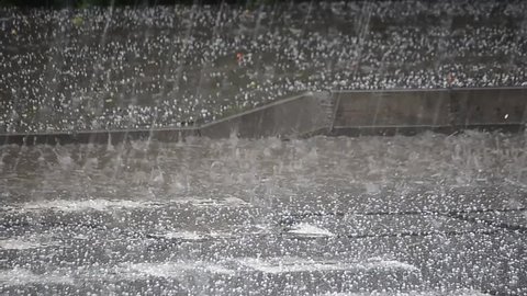 Hailstones downpour with massive rainfall. Hails destroying everything in it's path. Some cars protected from hails. Inside of car point of view, scary sound of hails dropping on roof and windshield.
