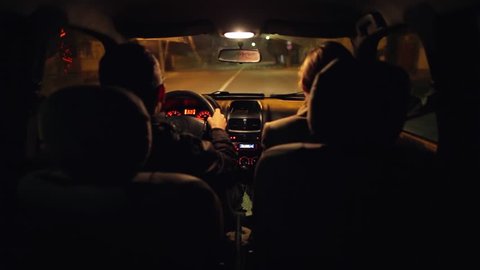 Listening to music in a small car at night