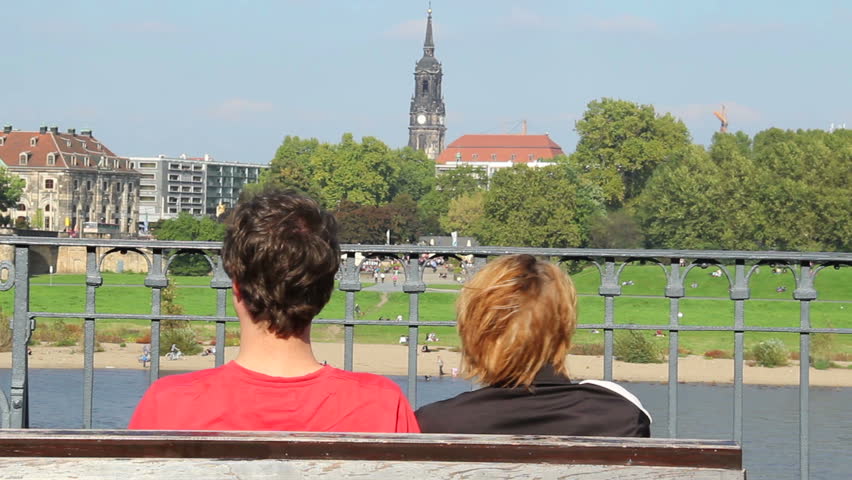 Teenage male female hug cold wind, sitting bench no face
