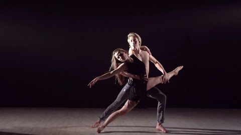 Dance partners demonstrating sensual dance pattern in slow motion