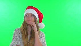 Christmas girl in santa hat on green screen background thinking,choosing, than showing pointing and presenting. Idea. Christmas and new year gifts. HD video footage 1080p