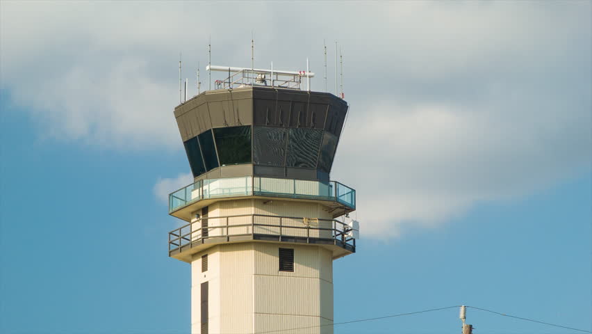 Closeup of the ATC Air Traffic Control Tower of Houston TX Hobby Airport HOU on a Sunny Afternoon with Radar Spinning between Radio Antennas during Good Texas Weather