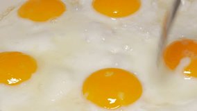 Eggs frying on ceramic pan close-up 4K 2160p UHD footage - Organic eggs in frying ceramic pan 4K 3840X2160 panning  UHD video