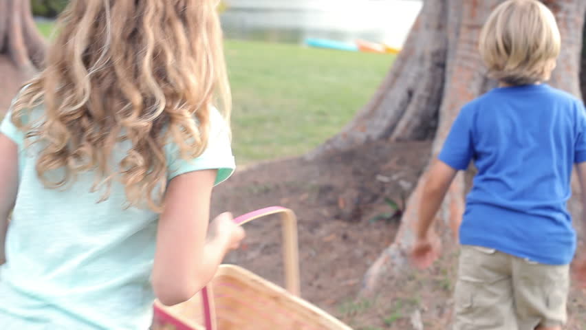 Two children searching for easter eggs in garden together. Shot on Canon 5D MkII at frame rate of 25fps
