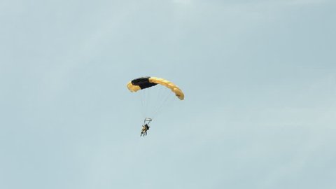 BELLEVILLE, MI, USA – AUGUST 2014:  US Army "Golden Knights" parachute team display a tandem landing at airfield during air show. Recorded in 4K, ultra high definition.