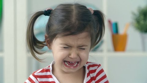 Portrait of little girl crying and sobbing