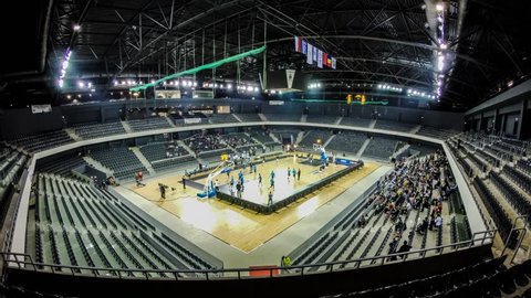CLUJ NAPOCA, ROMANIA - November 11: Time lapse of Cluj indoor arena seats filling up with crowd of basketball fans, at a U Mobitelco vs Trabzonspor Medical Park match.On Nov 11, 2014 in Cluj, Romania