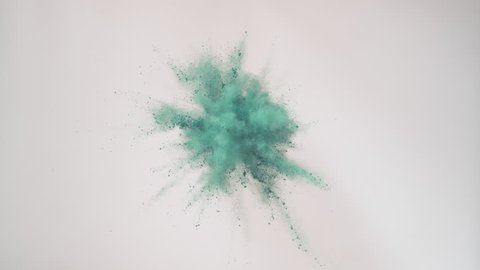 Colorful powder/particles fly after being exploded against black background. Shot with high speed camera, phantom flex 4K. 4K 30fps. Slow Motion. Unedited version is included at the end of clip.