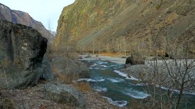Stock video 4K rock and ice on the freezing mountain river water clear