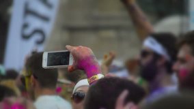 using smartphone to film at outdoor party