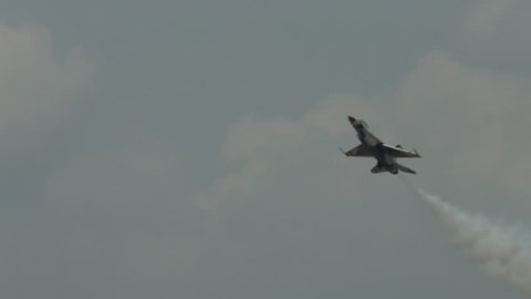 BELLEVILLE, MI, USA – AUGUST 2014: US Air Force "Thunderbirds" display team pilot makes a slow pass in an F-16 Fighting Falcon at an air show.  Recorded in 4K, ultra high definition.