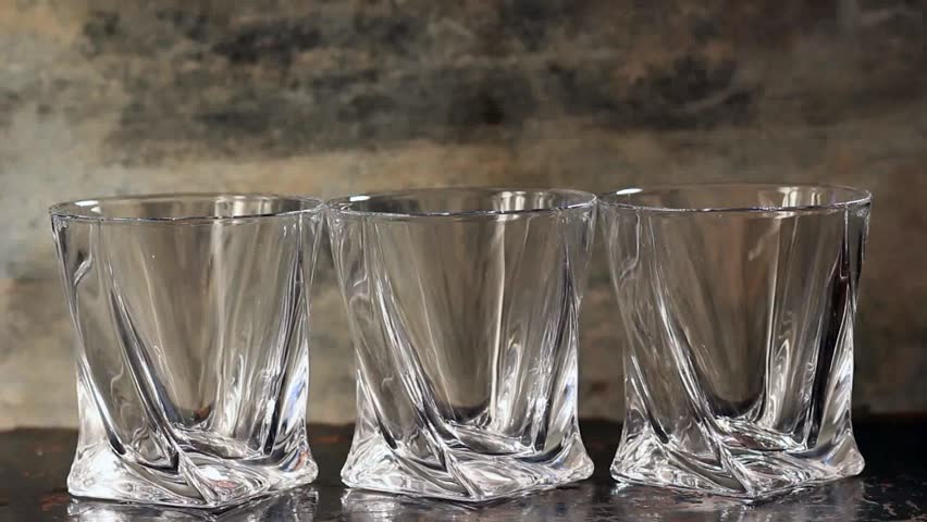 Pouring whiskey in three glasses
