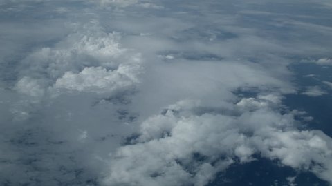 View of clouds through airplane window.