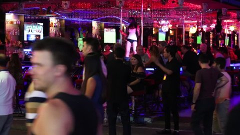 PATTAYA, THAILAND - NOVEMBER 15, 2014:  Walking Street is red-light district with many restaurants, go-go bars and brothels, that draws people, primarily for night life and sexual entertainments