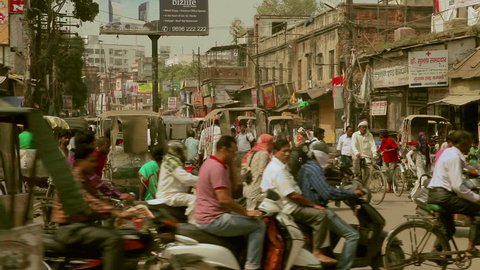 VARANASI,INDIA - October 29,2014 : Pedestrians walk in the middle of traffic jam on the streets of Varanasi,India