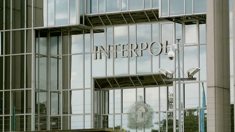 LYON, FRANCE - NOVEMBER 10: Panning over Interpol logo on headquarter building offices In Lyon, France. The International Criminal Police Organization is an intergovernmental police organization

