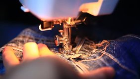 repair of jeans on the sewing machine