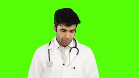 Locked-on shot of male doctor giving presentation against green background
