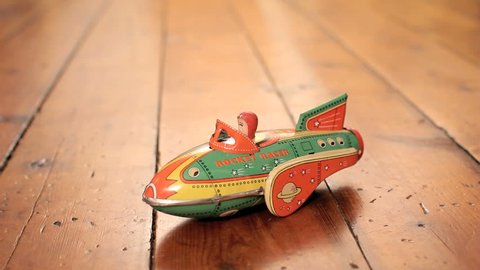 BOSTON, MA - April 7: Old vintage toy rocketship rolls on wooden floor on April 7, 2014. Tinplate was used in the manufacture of toys beginning in the mid-19th century.