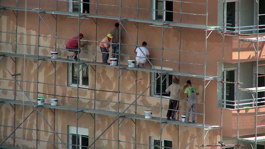 MONTENEGRO - PODGORICA 2014 - Workers on a building setting a facade | Shutterstock HD Video #7960633