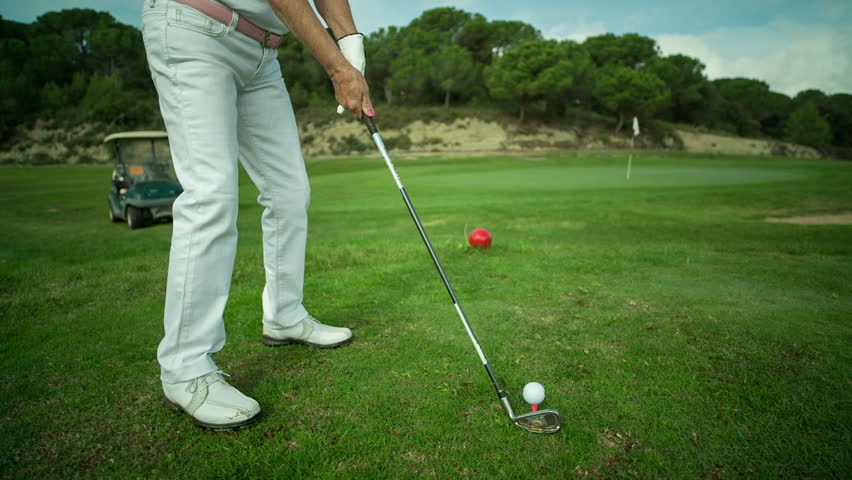 Senior woman hitting golf ball on the golf course Shutterstock HD Video #79...