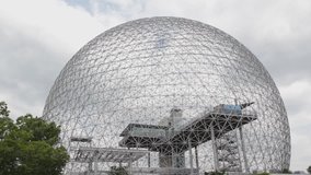 Geodesic dome. Designed by Richard Buckminster Fuller, the "Biosphere" was built for Expo 67 in Montreal, Quebec, Canada. Breeze in the trees and spinning windmill inside the dome.  - Powered by Shutterstock - Get 15% off with code: PIKWIZARD15