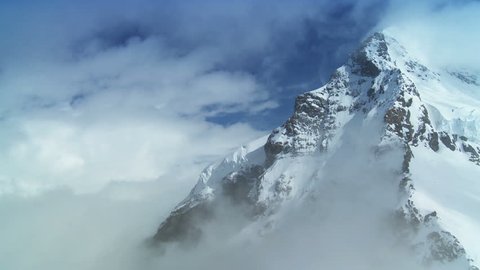 Time-lapse clouds over dramatic snow covered Monch mountain in Swiss Alps