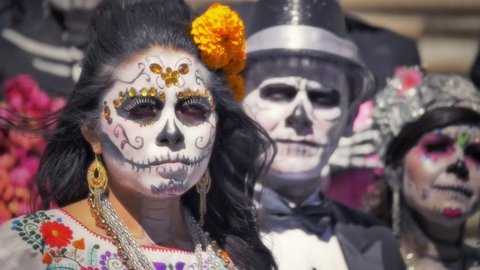 GUANAJUATO, MEXICO - M2 NOVEMBER 2014: Models dressed with traditional costumes and makeup of mexican skull called Catrina in the day of the dead 
