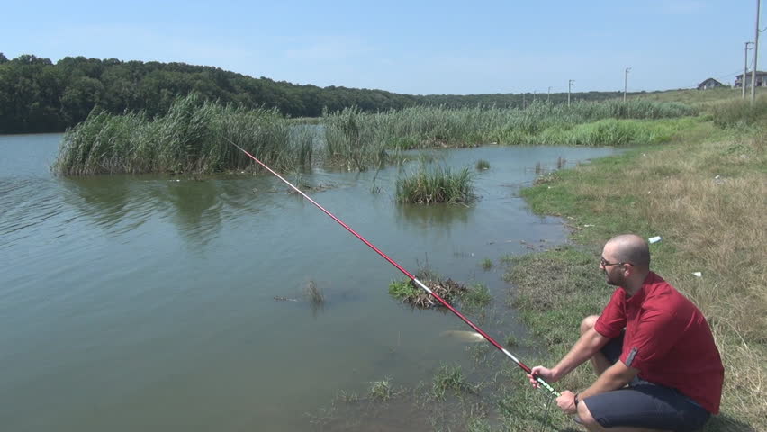 Fishing on wild lake man well dressed and sunglasses enjoy natural hobby outdoor