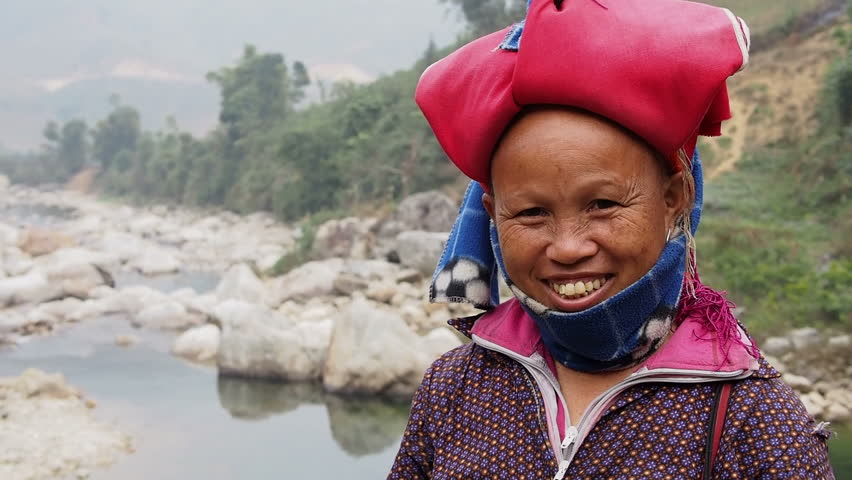 Happy woman from Red Dao minority group smiling, wearing traditional headdress, near Ban Ho village, Sapa District, Lao Cai Province, Vietnam.  Royalty-Free Stock Footage #7986094